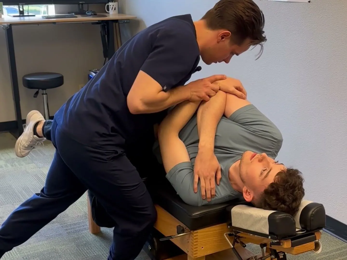 Dr. Douglas Ortyn performing a side-posture chiropractic adjustment at West Coast Chiropractic